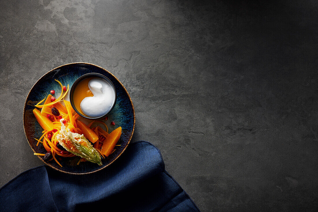 Pumpkin soup with coconut foam and stuffed courgette flowers