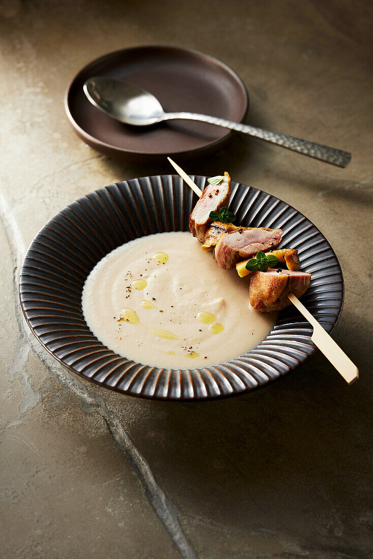 Chestnut soup with quail and saté mushroom skewers