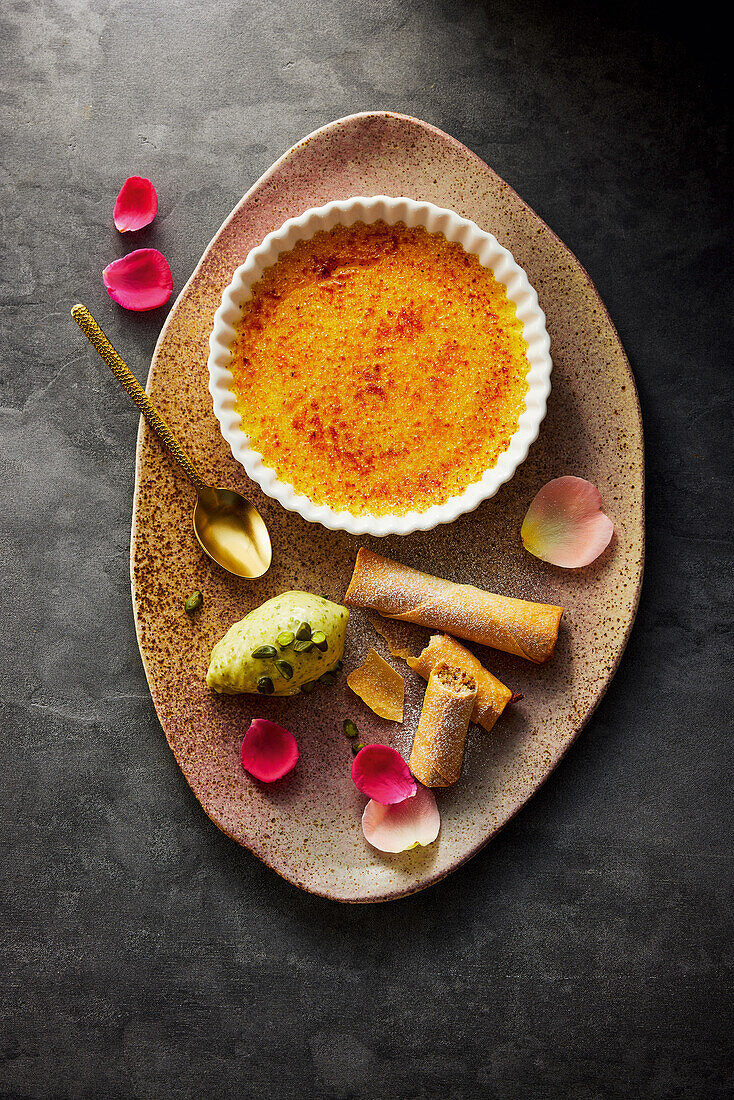 Passion fruit crème brûlée with pistachio-honey ice cream and filo rolls