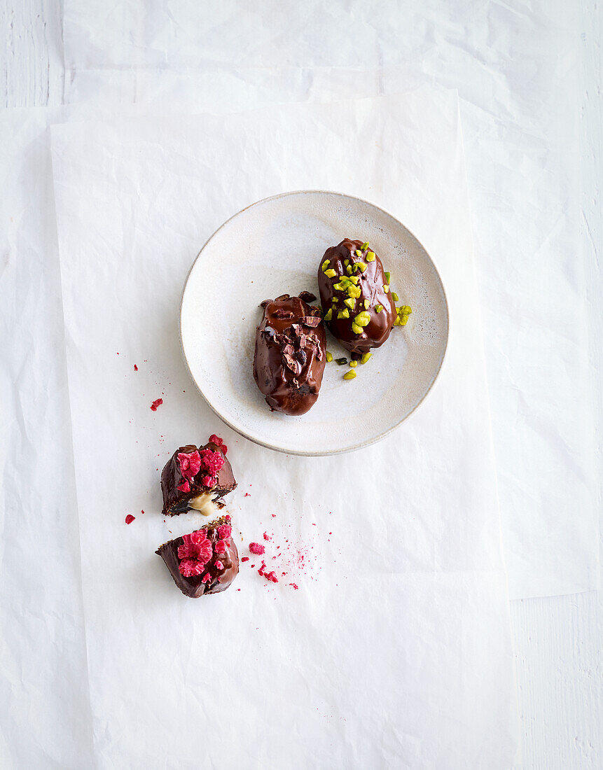 Dates coated in chocolate with pistachios