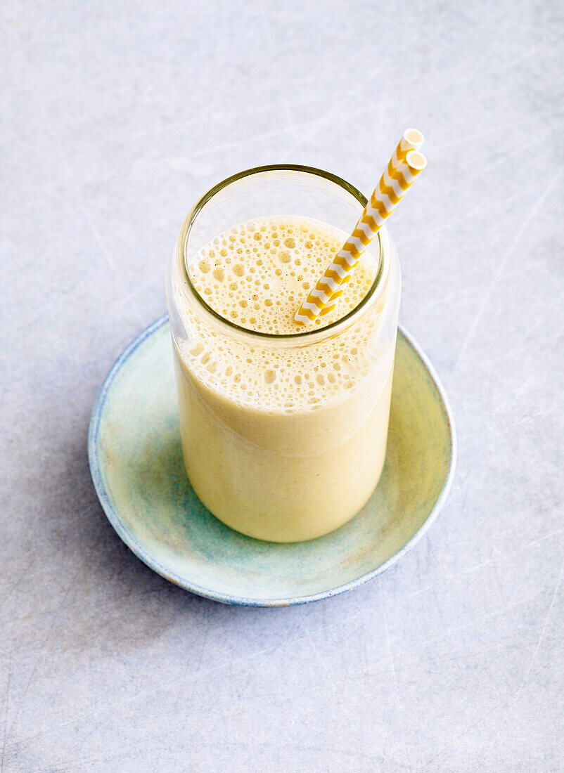 Sports shake with banana, soya drink, processed flakes and nut butter