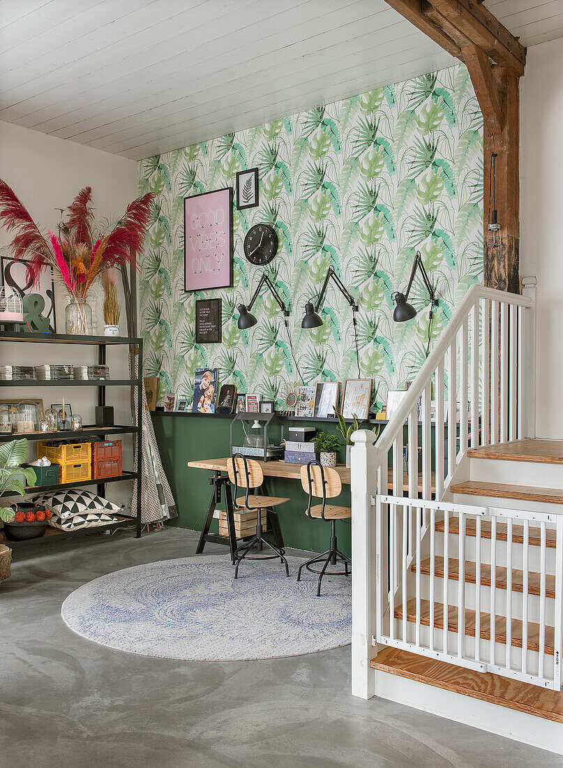 Work area with palm tree wallpaper and wall lamps