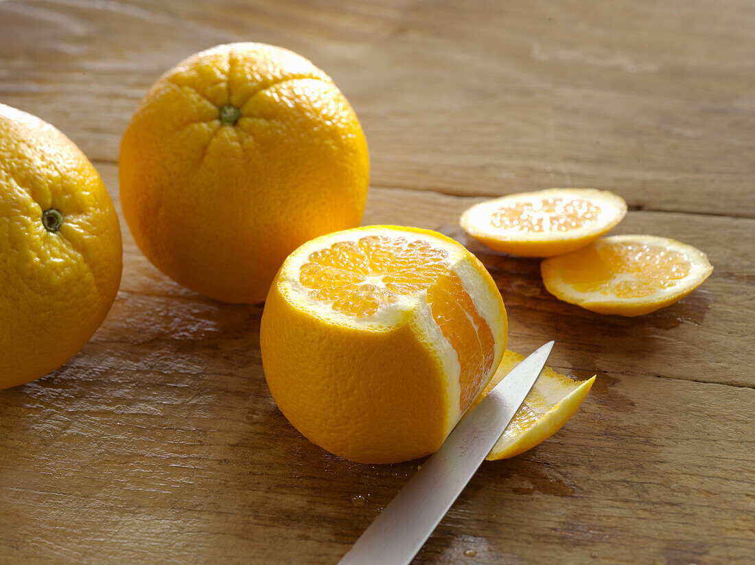 An orange being filleted