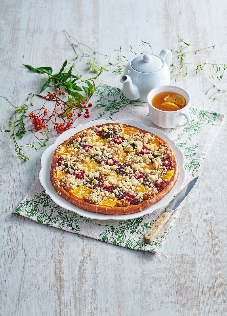 Yeast cake with cream cheese, raspberries, apricots and crumble