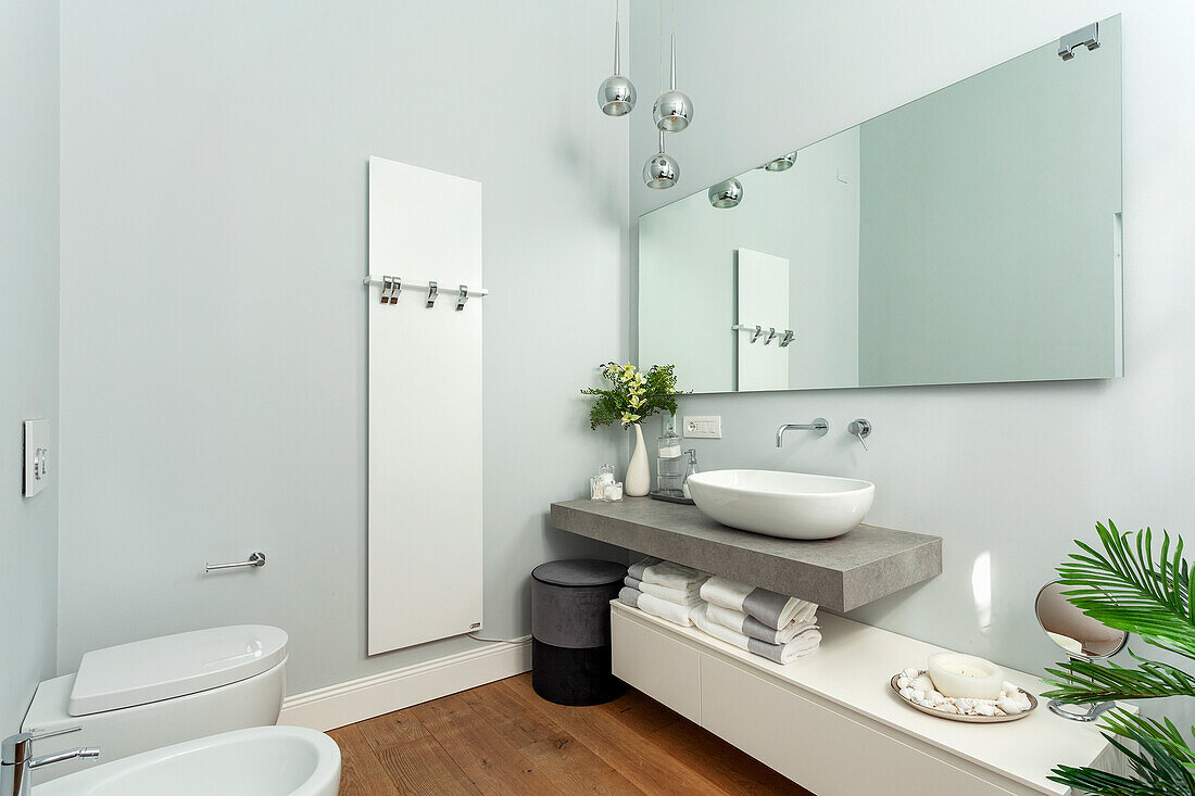 Minimalist bathroom with washbasin on concrete slab