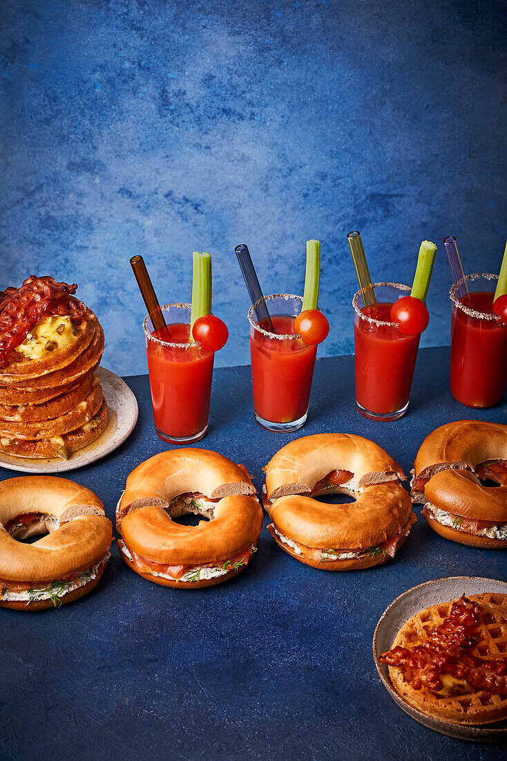 Cream cheese bagels with smoked salmon and capers, bacon waffles, Bloody Mary