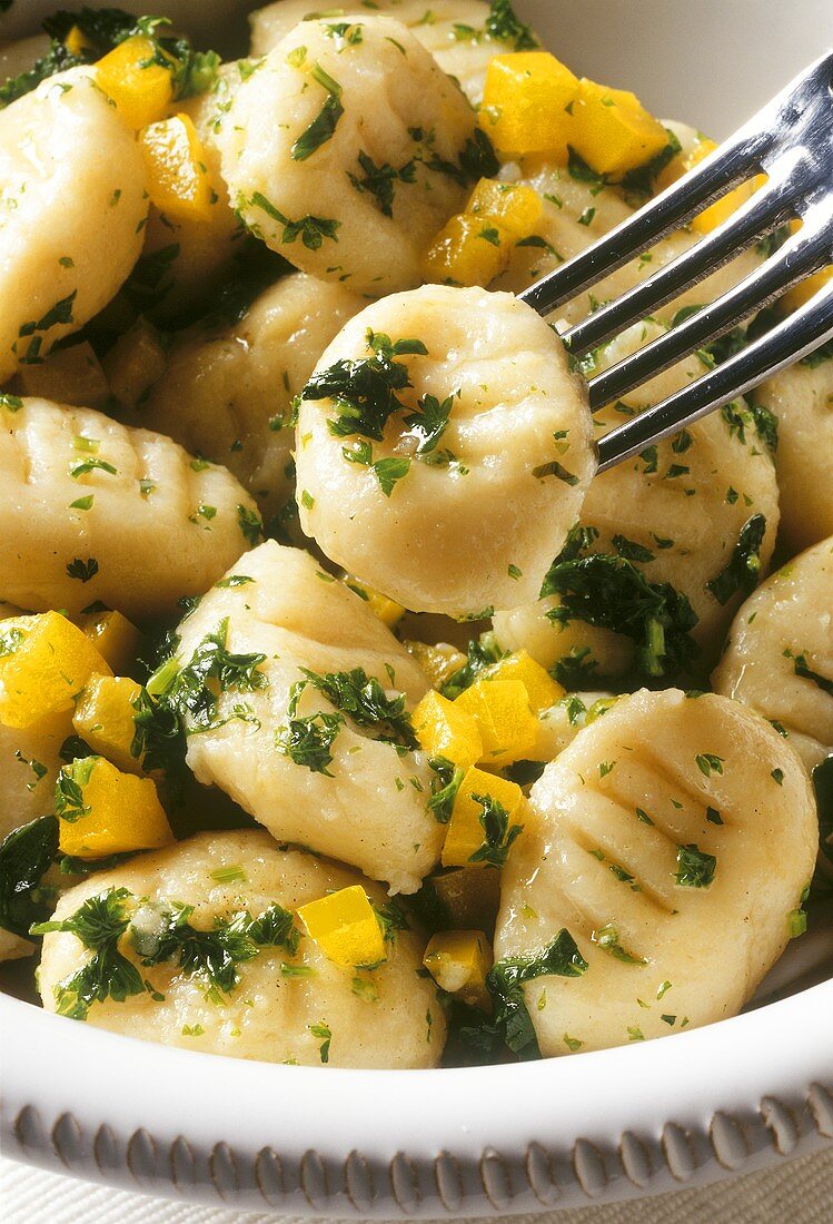 Parmesan gnocchi with yellow pepper & parsley in dish