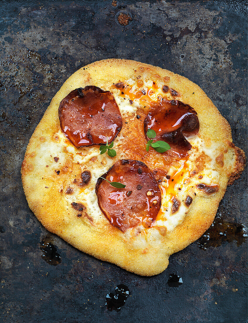 Spelt pizza with pepperoni salami and mozzarella