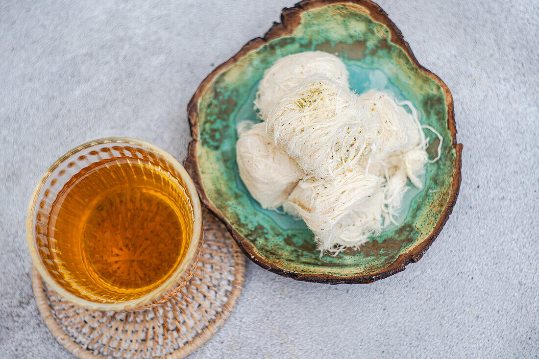 Turkish dessert Pismaniye with pistachios and tea