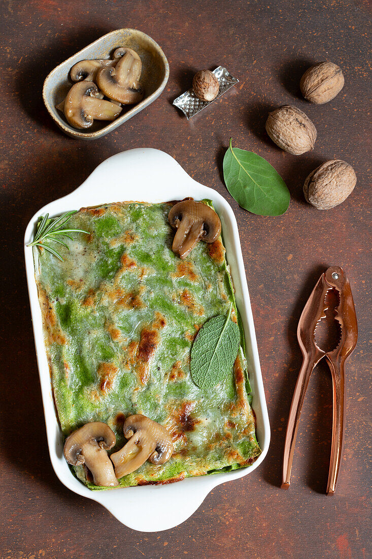 Green veggie lasagne with ricotta, mushrooms, caciocavallo and walnuts