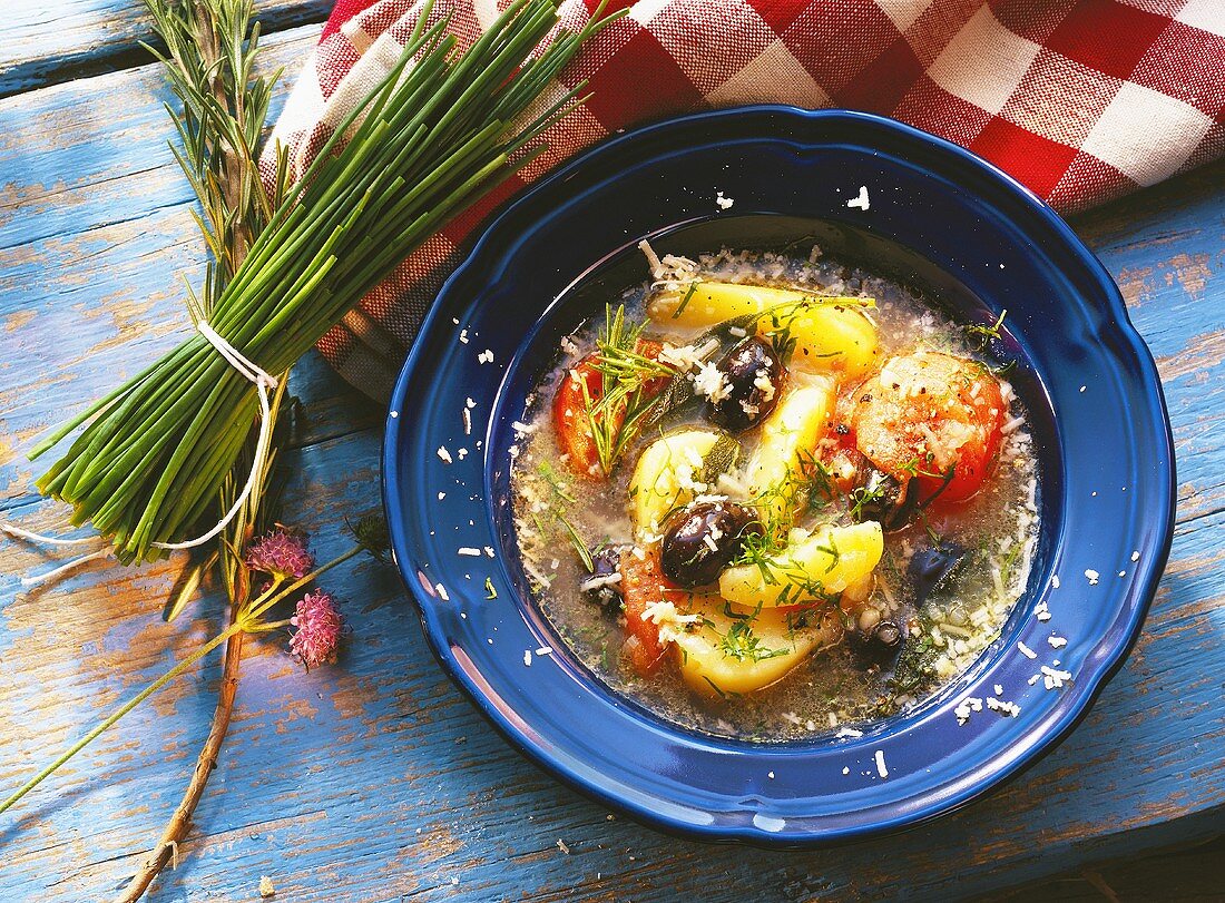 Potato & vegetable soup with tomatoes & black olives