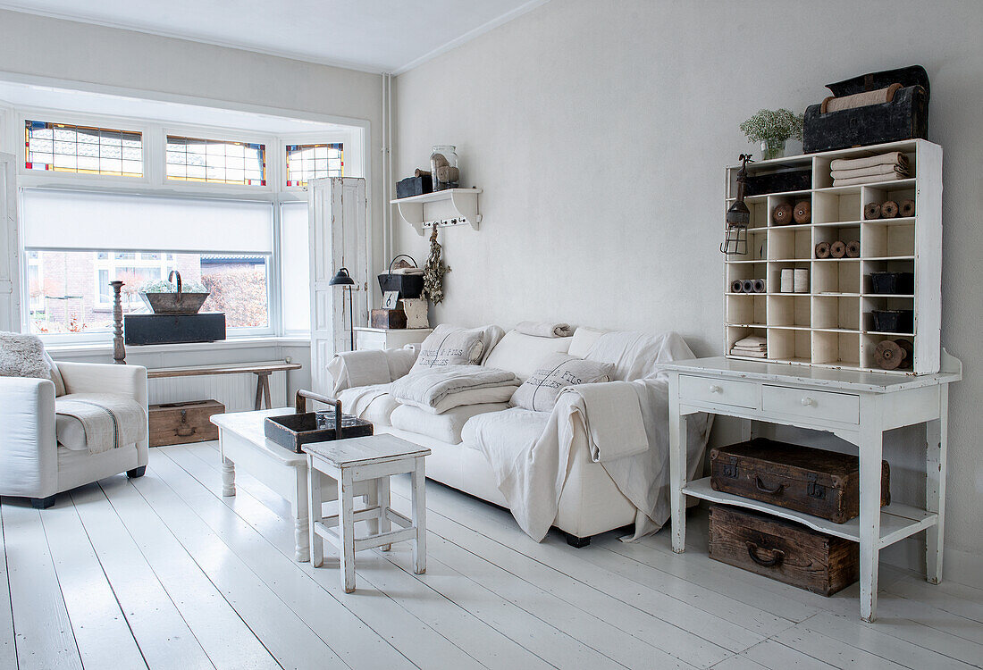 Country-style living room with white wooden furniture and white wooden flooring