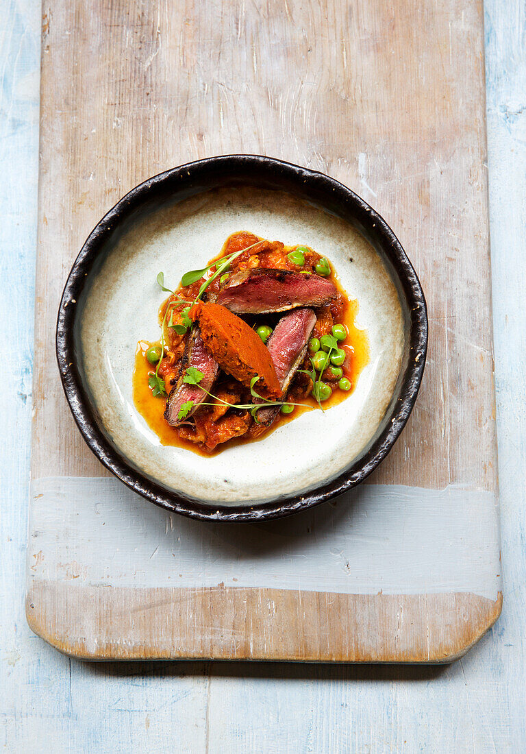 Roasted duck breast with Asian spices and peas