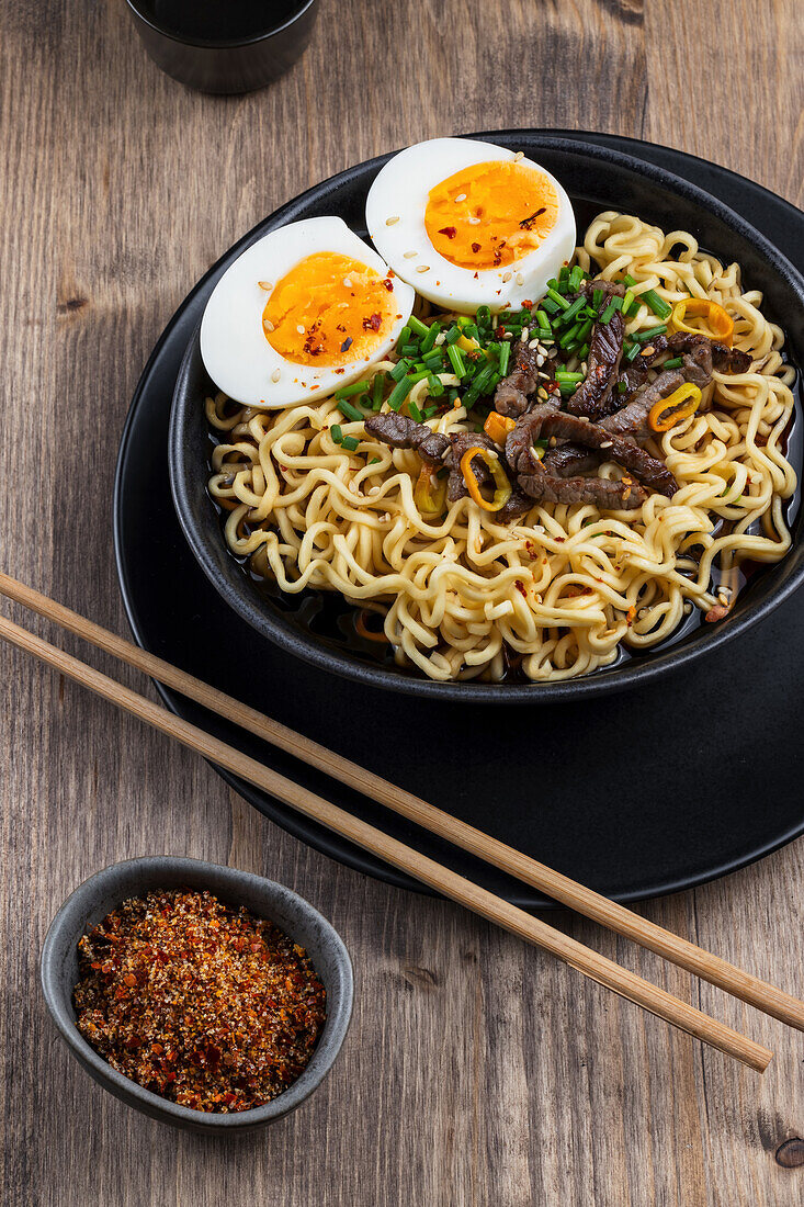 Asian noodle soup with egg and beef