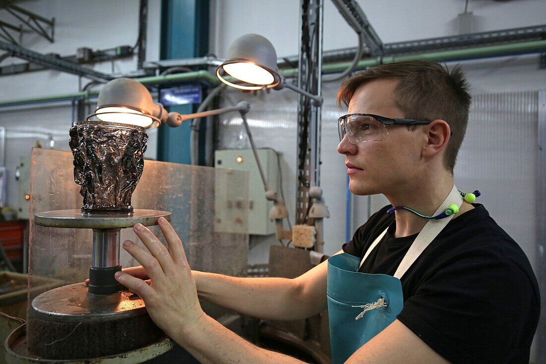 France,Bas Rhin,Wingen sur Moder,Lalique factory of Wingen on Moder,the cold hall,checking the perfect flatness of the foot of the vase,Lalique is a French luxury company,founded by the master glassmaker and French jewelery designer Rene Lalique in 1888