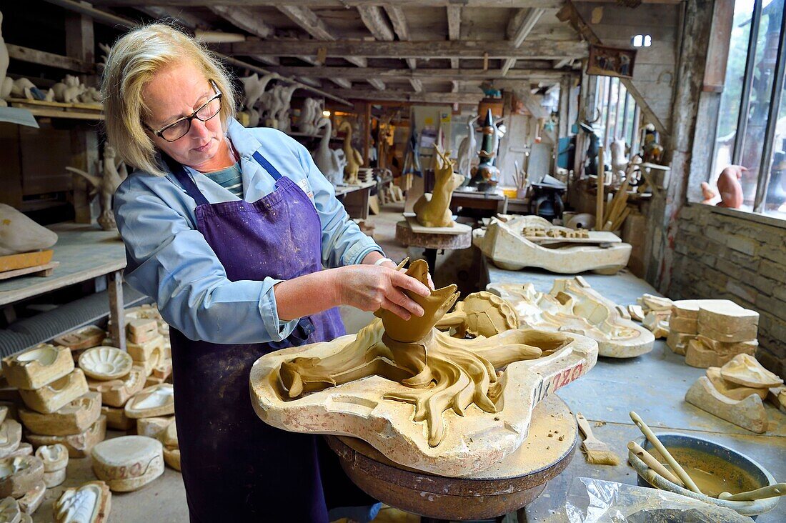 France,Calvados,Pays d'Auge,Bavent,pottery of Mesnil de Bavent,the ceramist Annie Richier demolding and finishing a finial (hip-knob) representing a cock in the workshop