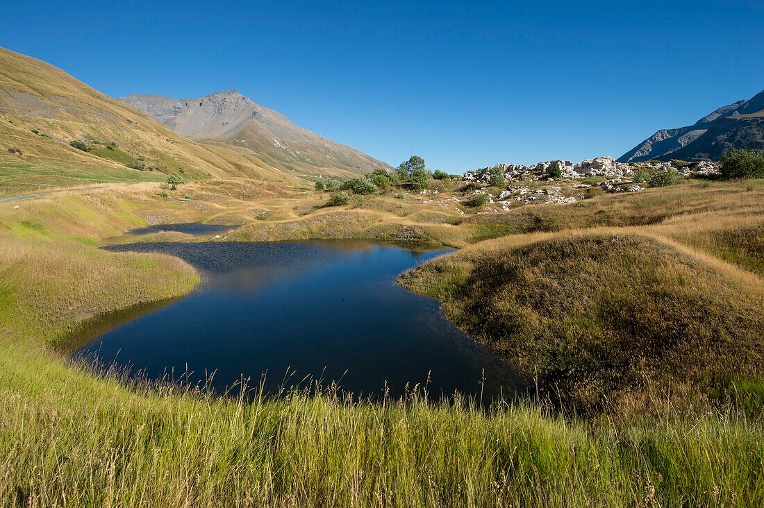 France,Savoie,Haute Maurienne,Val Cenis,Mont Cenis Pass,dam lake and concretions of gypsum,a funnel of dissolution created a small lake