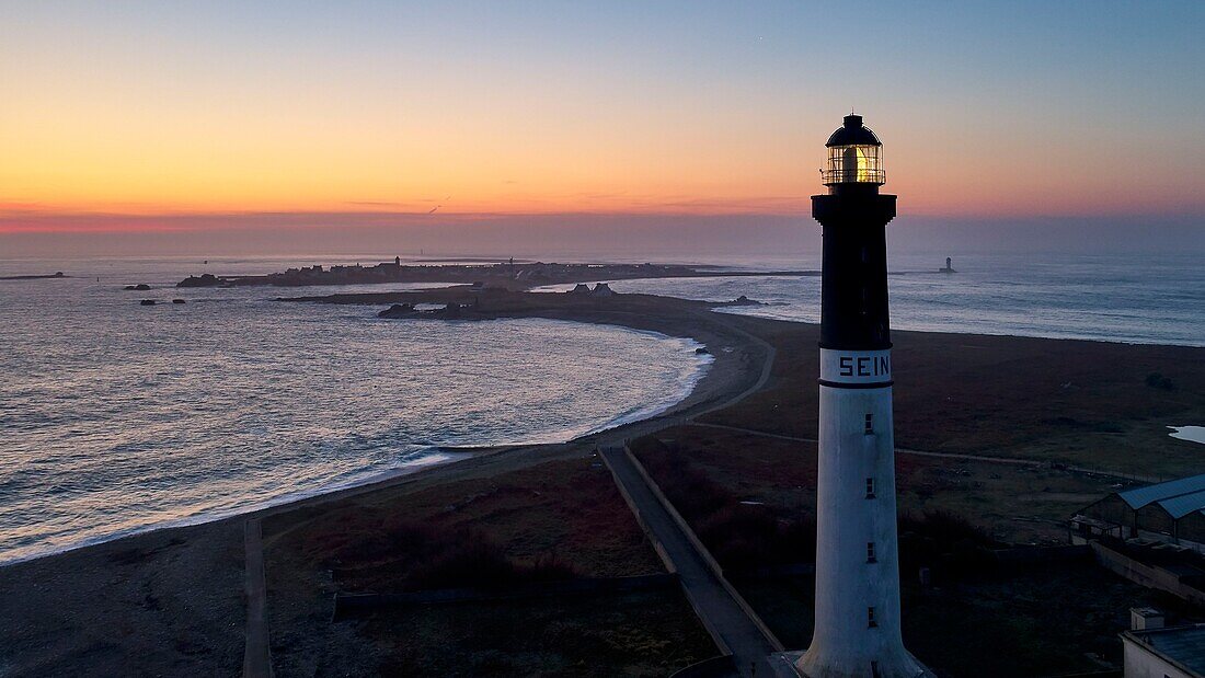 France,Finistere,Iroise Sea,Iles du Ponant,Parc Naturel Regional d'Armorique (Armorica Regional Natural Park),Ile de Sein,labelled Les Plus Beaux de France (The Most Beautiful Village of France) the Sein lighthouse in the early morning (Goulenez lighthouse) (aerial view)