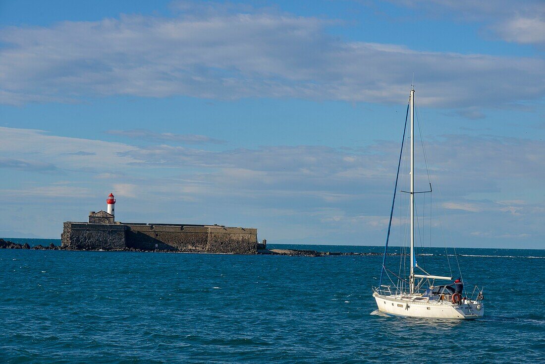 France,Herault,Agde,Cape of Agde,Fort of Brescou with a sailboat in the foreground