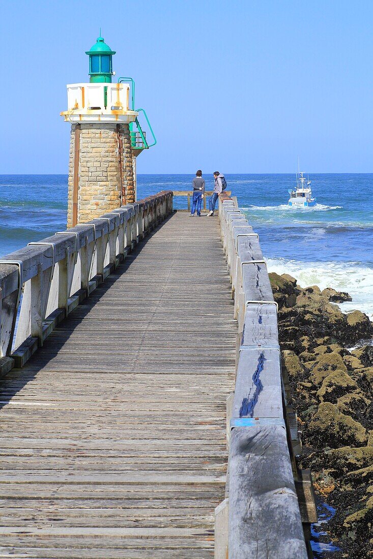 France,Landes,Capbreton,boom and lighthouse on the Atlantic coast with a fishing boat going off