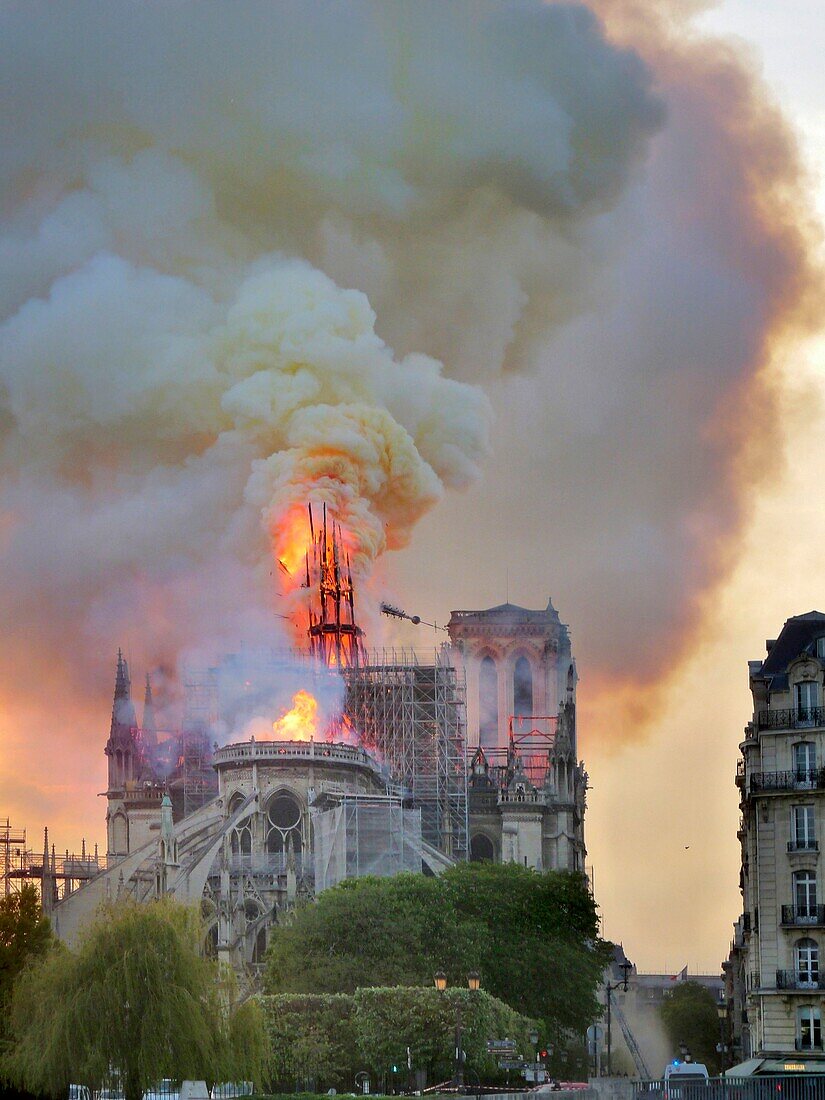 [ Unpublished - Exclusive ] France,Paris,area listed as World Heritage by UNESCO,Notre Dame Cathedral of 14th century Gothic architecture during the fire of 15th April 2019,overview of the fall of the arrow