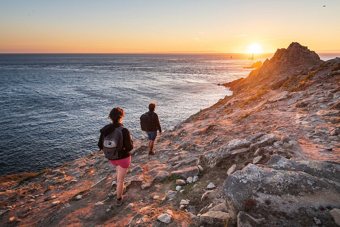 France,Finistere,Plogoff,hiker at sunset at Pointe du Raz