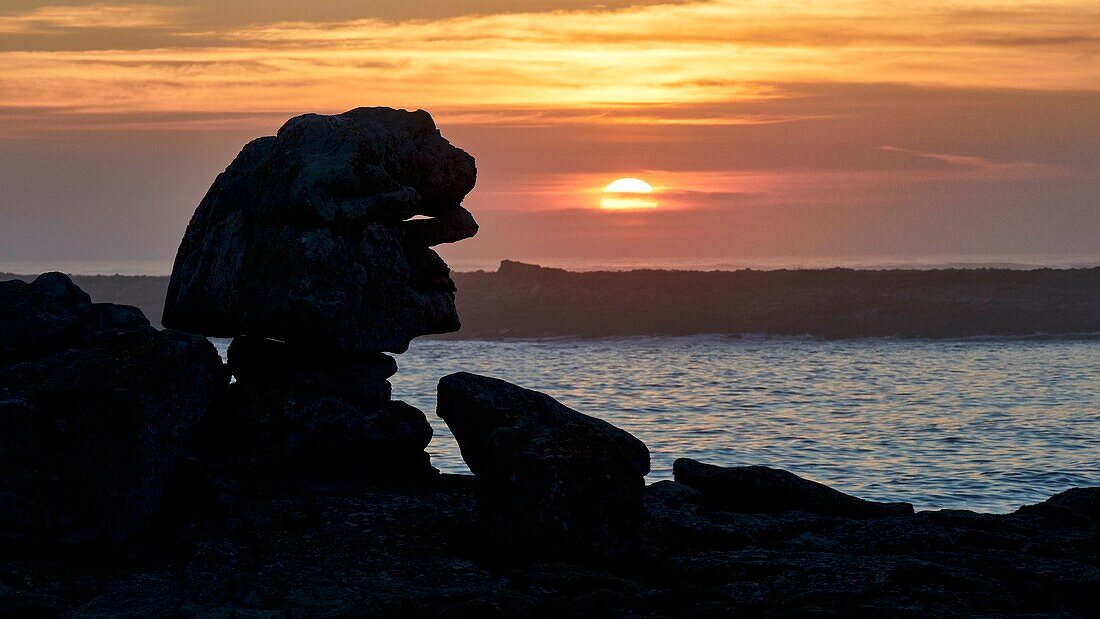 France,Finistere,Iroise Sea,Iles du Ponant,Parc Naturel Regional d'Armorique (Armorica Regional Natural Park),Ile de Sein,labelled Les Plus Beaux de France (The Most Beautiful Village of France),rock "le Sphinx" at sunset