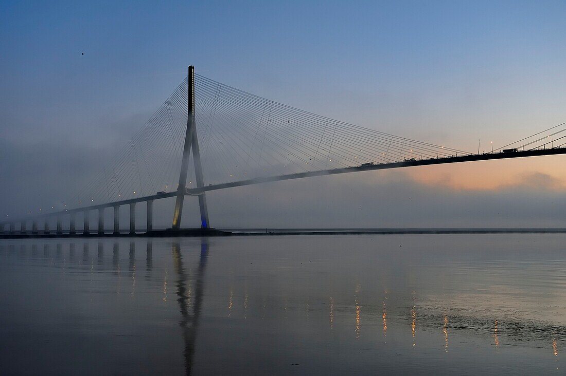 France,between Calvados and Seine Maritime,the Pont de Normandie (Normandy Bridge) in the mists of dawn,it spans the Seine to connect the towns of Honfleur and Le Havre