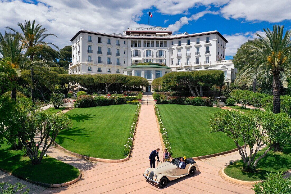 France,Alpes Maritimes,Saint Jean Cap Ferrat,Grand-Hotel du Cap Ferrat,a 5 star palace from Four Seasons Hotel,the doorman welcomes customers in a Morgan Roadster 4/4 (aerial view)