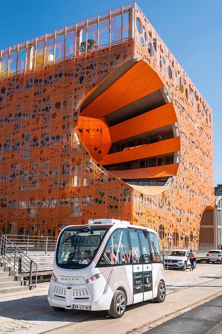 France,Rhone,Lyon,La Confluence district south of the Presqu'ile,close to the confluence of the Rhone and the Saone rivers,quai Rambaud along the former docks,Pavillon des Salins also called Cube Orange by the architects Dominique Jakob and Brendan Mac Farlane and Navly,autonomous minibus without driver