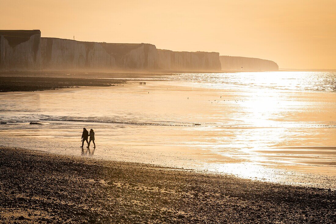 France,Somme,Bay of Somme,Picardy Coast,Ault,Walkers on beach at the foot of the cliffs