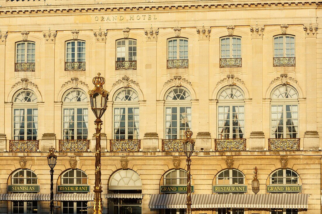 France,Meurthe et Moselle,Nancy,Stanislas square (former royal square) built by Stanislas Leszczynski,king of Poland and last duke of Lorraine in the 18th century,listed as World Heritage by UNESCO,facade of the Grand Hotel de la Reine and street lamps iron works by Jean Lamour