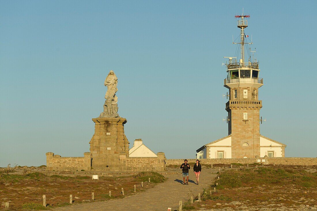 France,Finistere,Plogoff,hiker at sunset at Pointe du Raz,in front of the semaphore