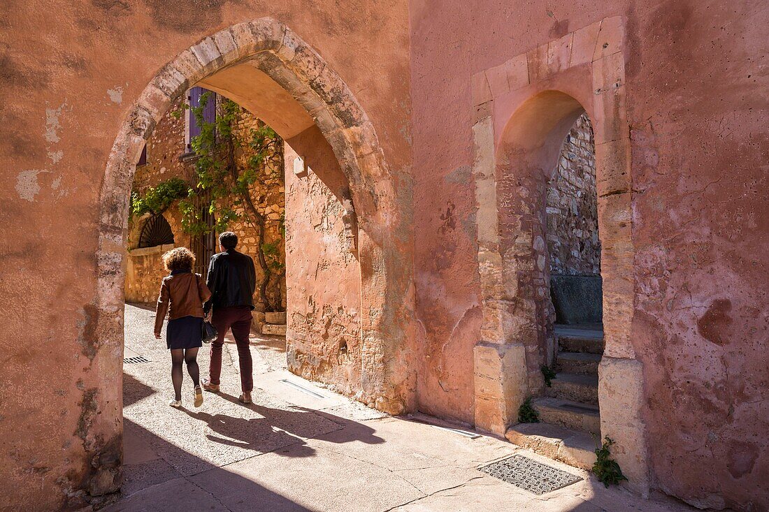 France,Vaucluse,regional natural park of Luberon,Roussillon,labeled the most beautiful villages of France,old door of Castrum (fortified enclosure) surmounted by the belfry or clock tower