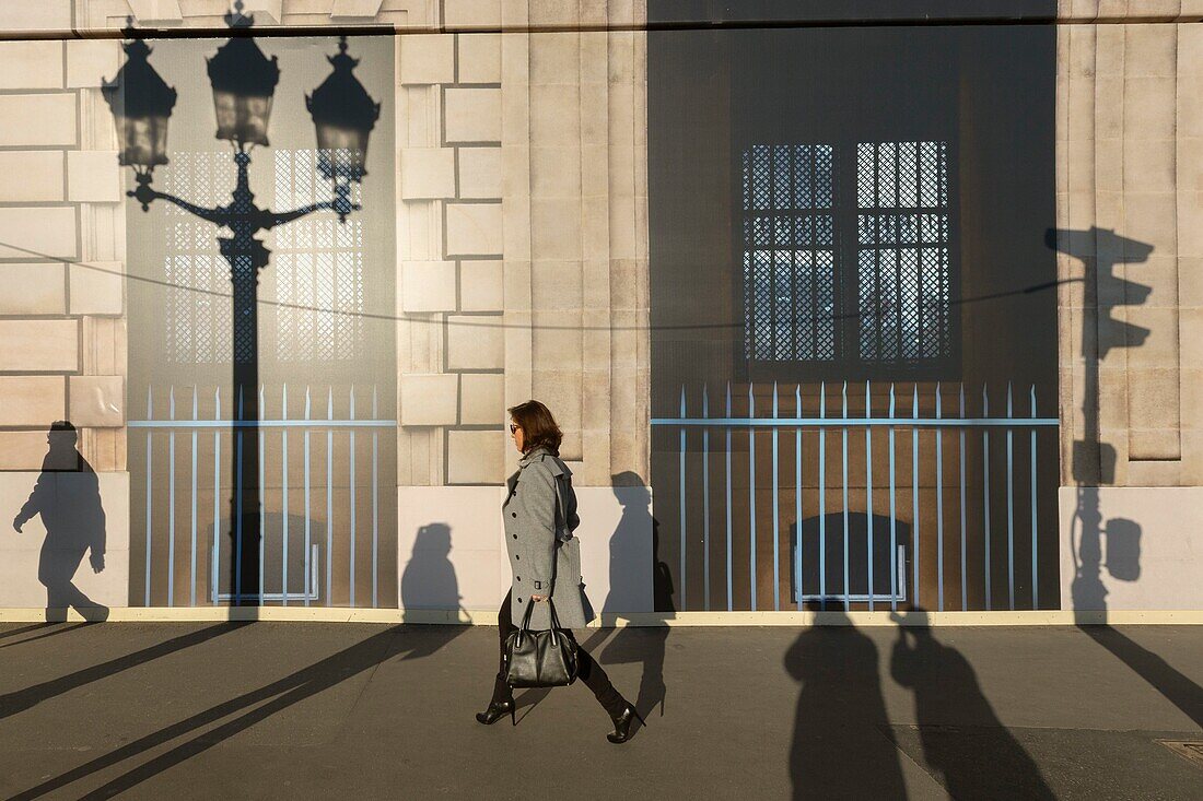 France,Paris,trompe l'oeil on afacade Place de la Concorde woman and shadows