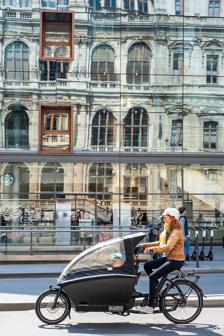 France,Rhone,Lyon,historic district listed as a UNESCO World Heritage site,Cordeliers square,reflection of the Palais de la Bourse de Lyon in the window of Monoprix