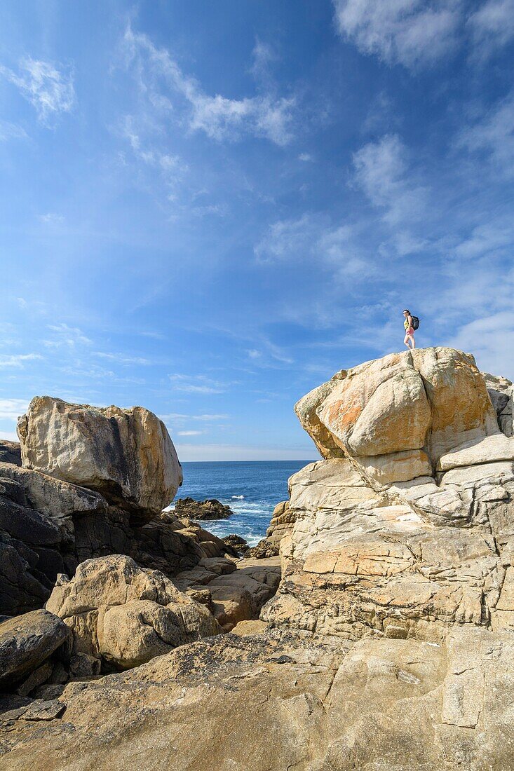 France,Finistere,Penmarch,hiker on the rocks of Saint-Guenolé