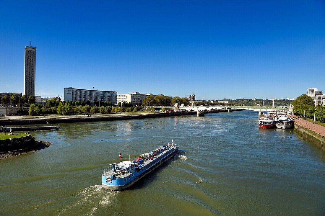 France,Seine Maritime,Rouen,barge on the Seine and the Boieldieu Bridge,the departmental archives tower of Seine-Maritime in the background