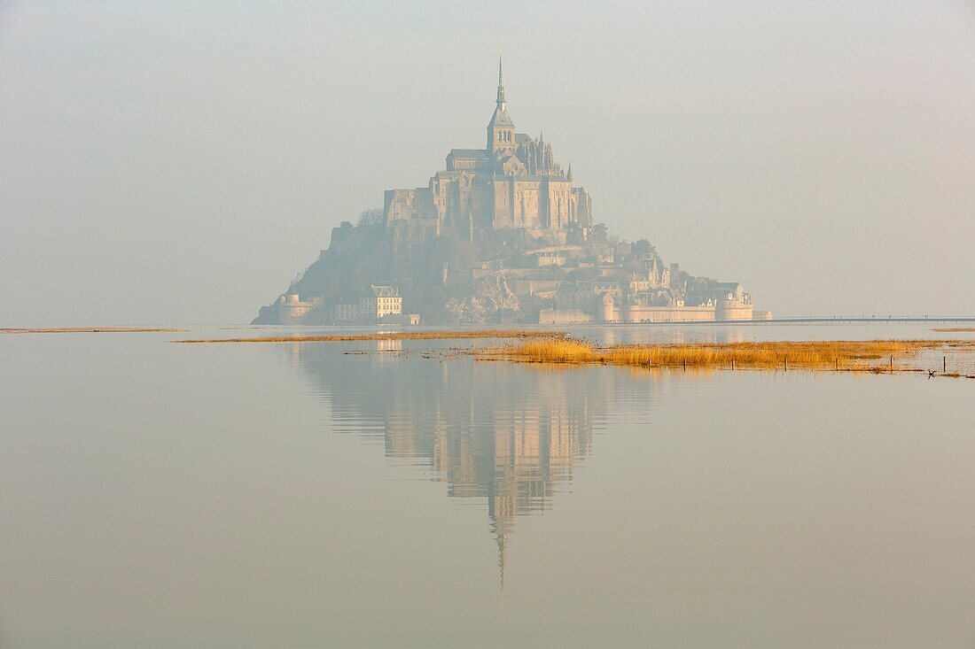France,Manche,Mont Saint Michel bay listed as World Heritage by UNESCO,Mont Saint Michel at high tide from the dam and footbridge by architect Dietmar Feichtinger