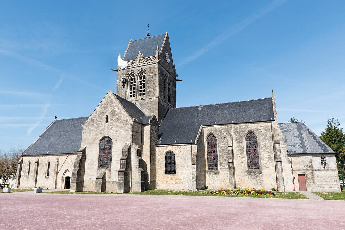 France,Manche,Cotentin,Sainte Mere Eglise,one of the first communes of France liberated on June 6,1944,model of American paratrooper John Steele (1912-1969) from the 505th Parachute Infantry Regiment who landed on the bell tower of the church