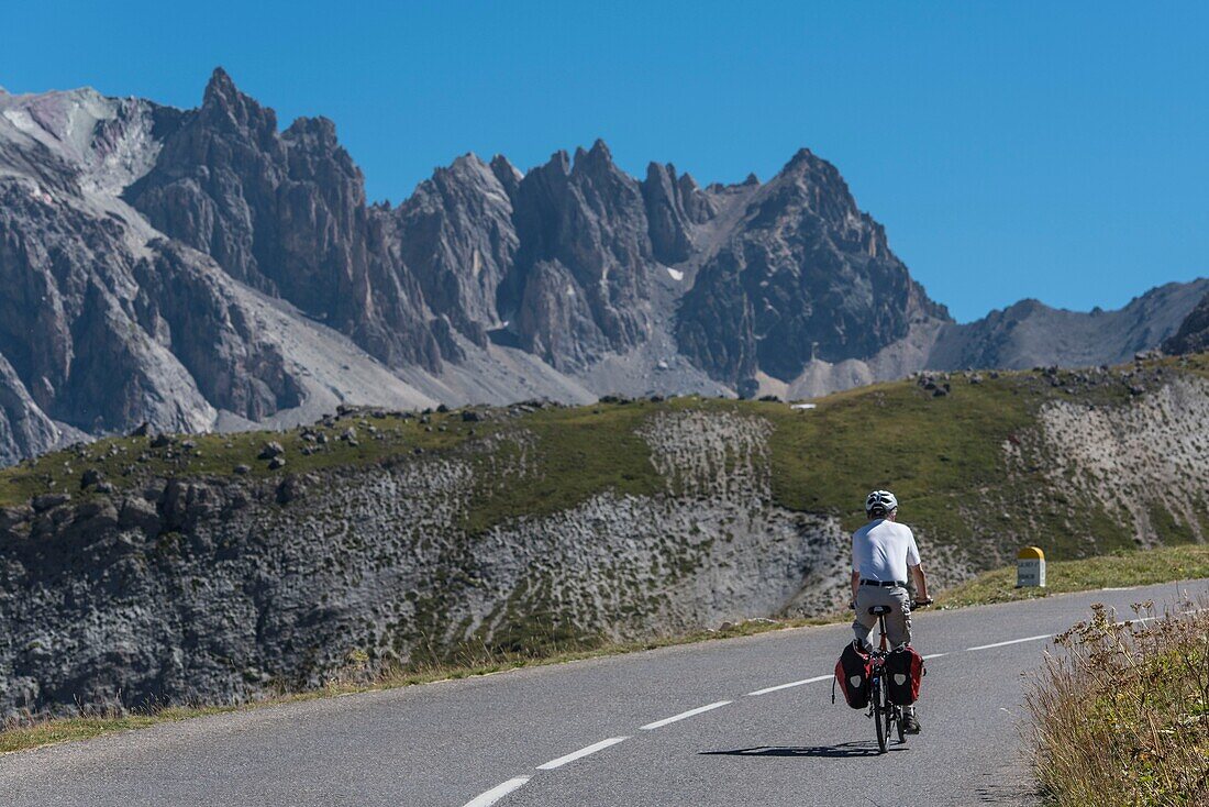 France,Savoie,Massif des Cerces,Valloire,cycling ascension of the Col du Galibier,one of the routes of the largest cycling area in the world,an itinerant cyclist apprecie the grandiose landscape of the steep reliefs of the massif des Cerces