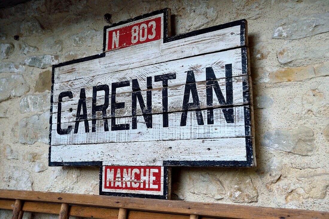 France,Manche,Carentan,L'Atelier,the wartime groceries café,reconstituted by Sylvie and Jean-Marie Caillard,collectors of 1940s military and civilian objects,wooden Carentan city sign