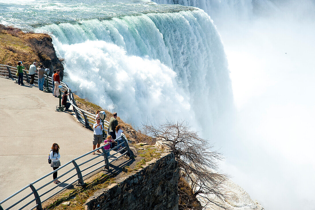 Tourists Enjoying The View Of Niagara Falls,Ontario And New York Border,Canada And United States Of America