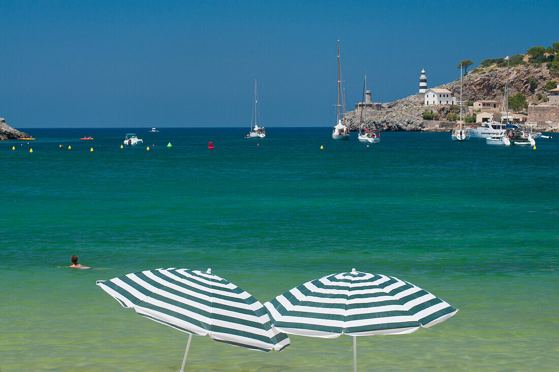 Spain,Pair of beach umbrellas on beach of Port Soller,Majorca