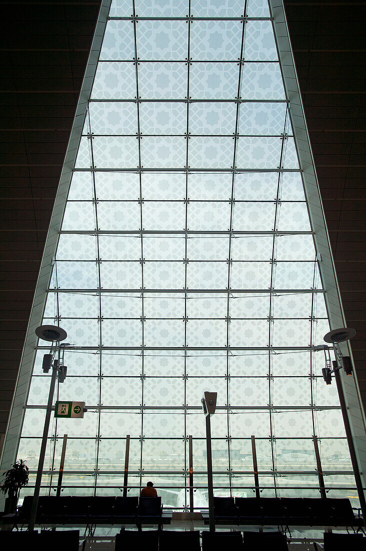 United Arab Emirates,Silhouette of man waiting in terminal of Dubai International Airport,Dubai