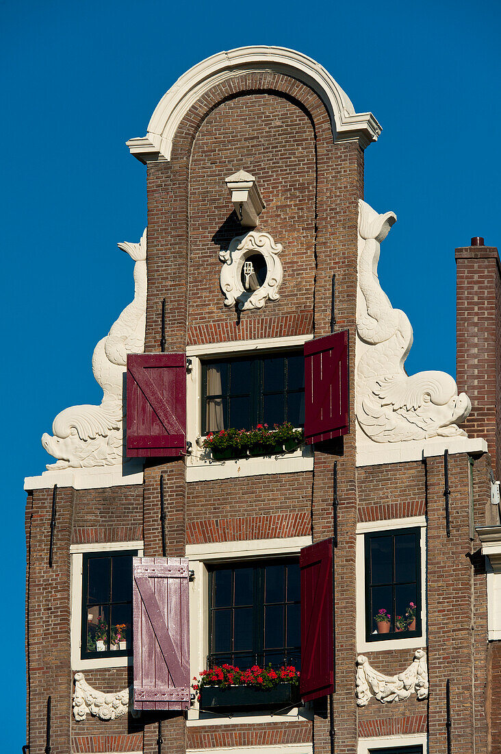 Holland,Detail of top of thin traditional gabled house,Amsterdam