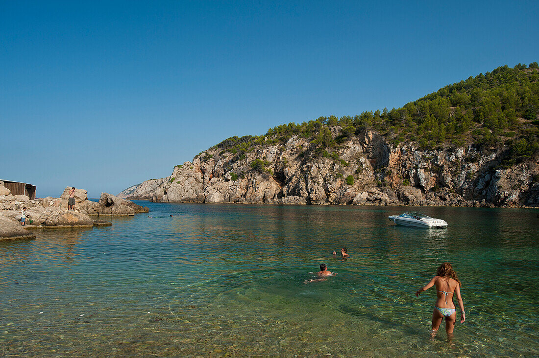 Spain,People going to swim off Cala d'en Serra beach,Ibiza