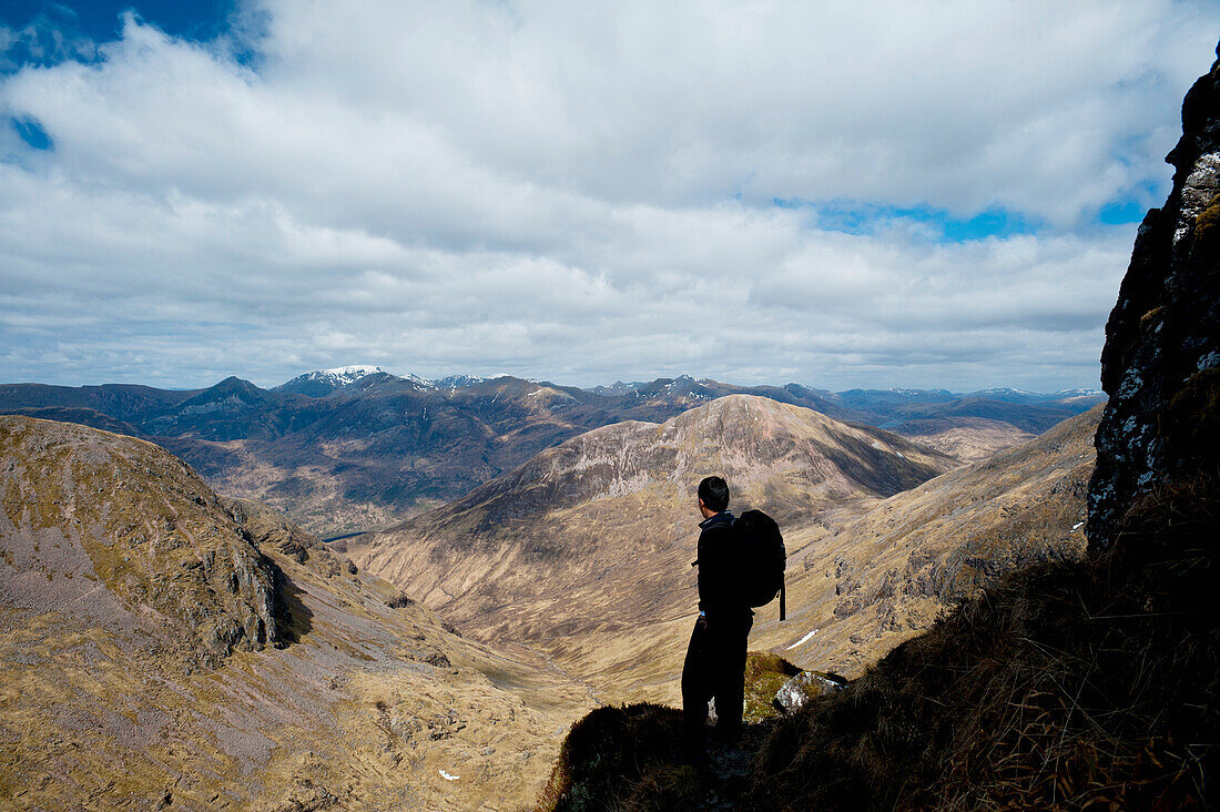 UK,Scotland,Argyll,Silhouette of man admiring view from Aonach Eagach Ridge,Glen Coe