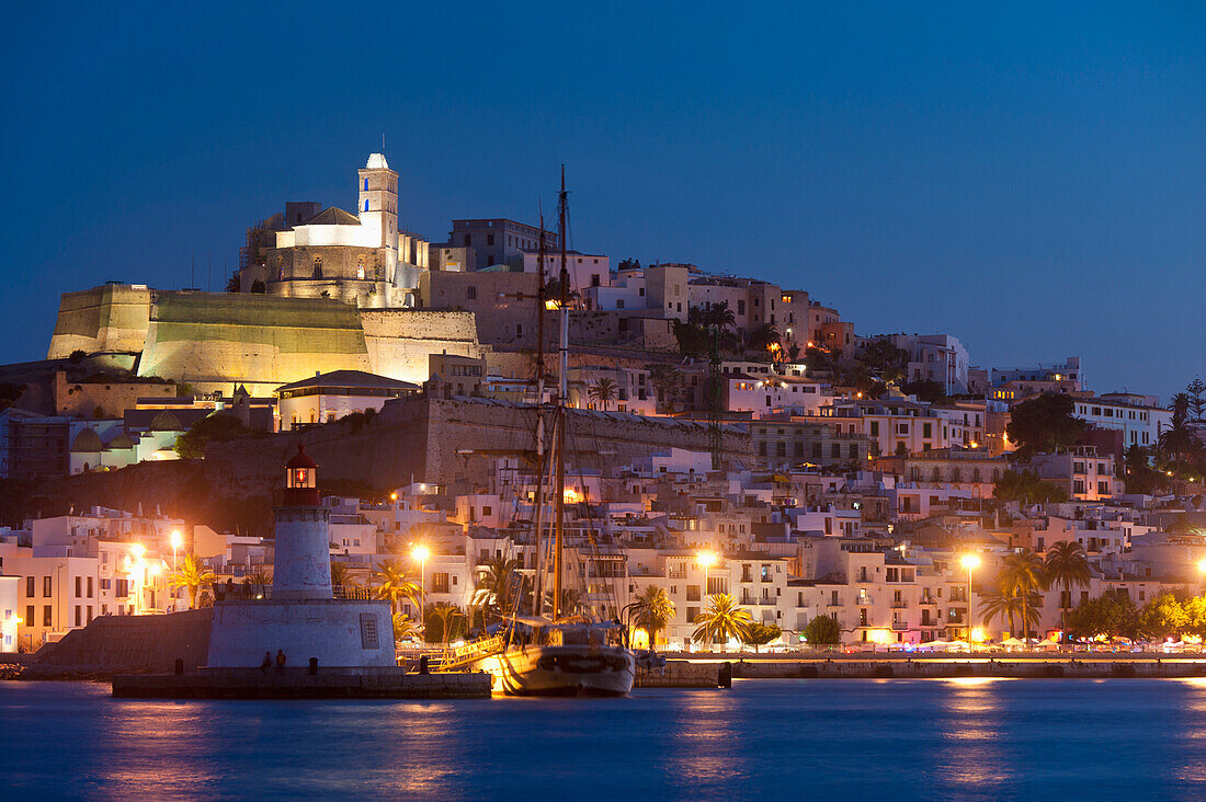 Spain,Looking across harbor to Ibiza town at dusk,Ibiza