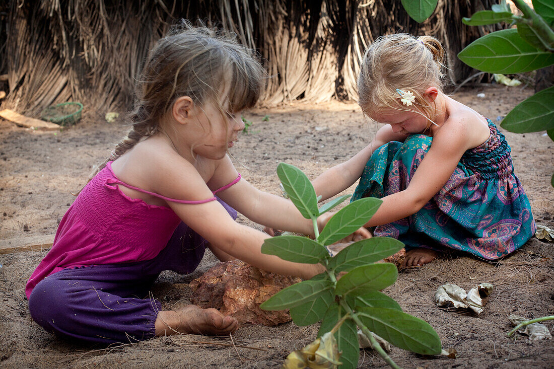 Kiki Lett and Isla Reynolds play together,on Turtle Beach,Goa,India.